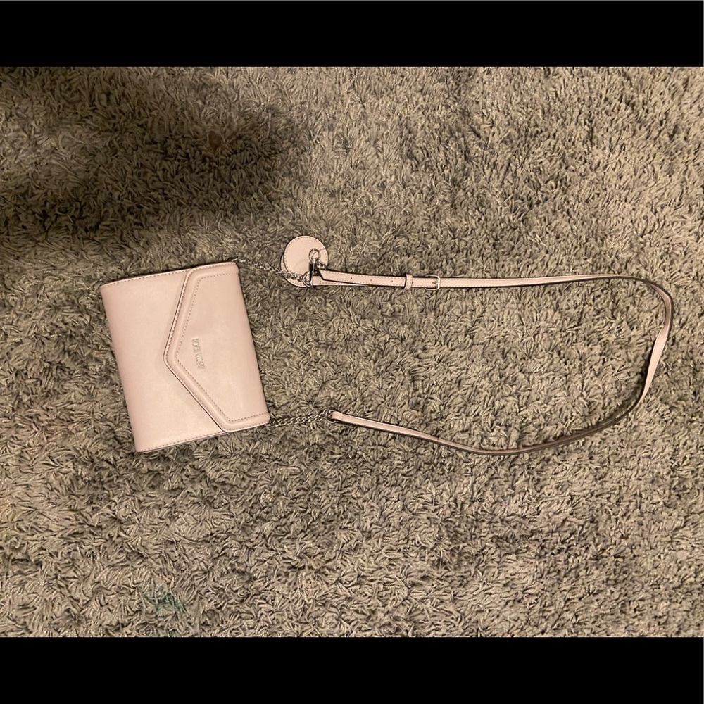 Light purple over the shoulder purse, has little mirror attached.